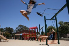 girl jumping off swing
