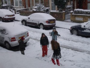 Four children playing in a snowy street