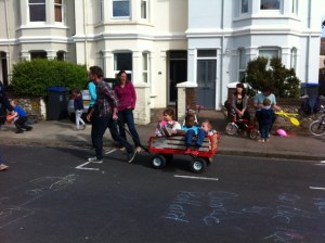 Man pulling children in trailer