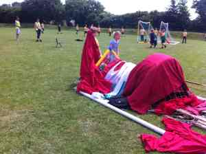 Children in school playground with scrap materials