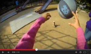 Child throwing ball at rocks