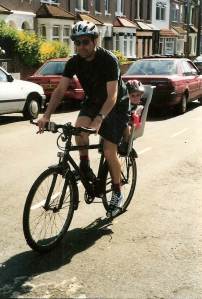 Me on my bike with my 3-year-old daughter in a bike seat