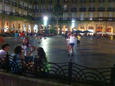 Children playing at Plaza Nueva after dark