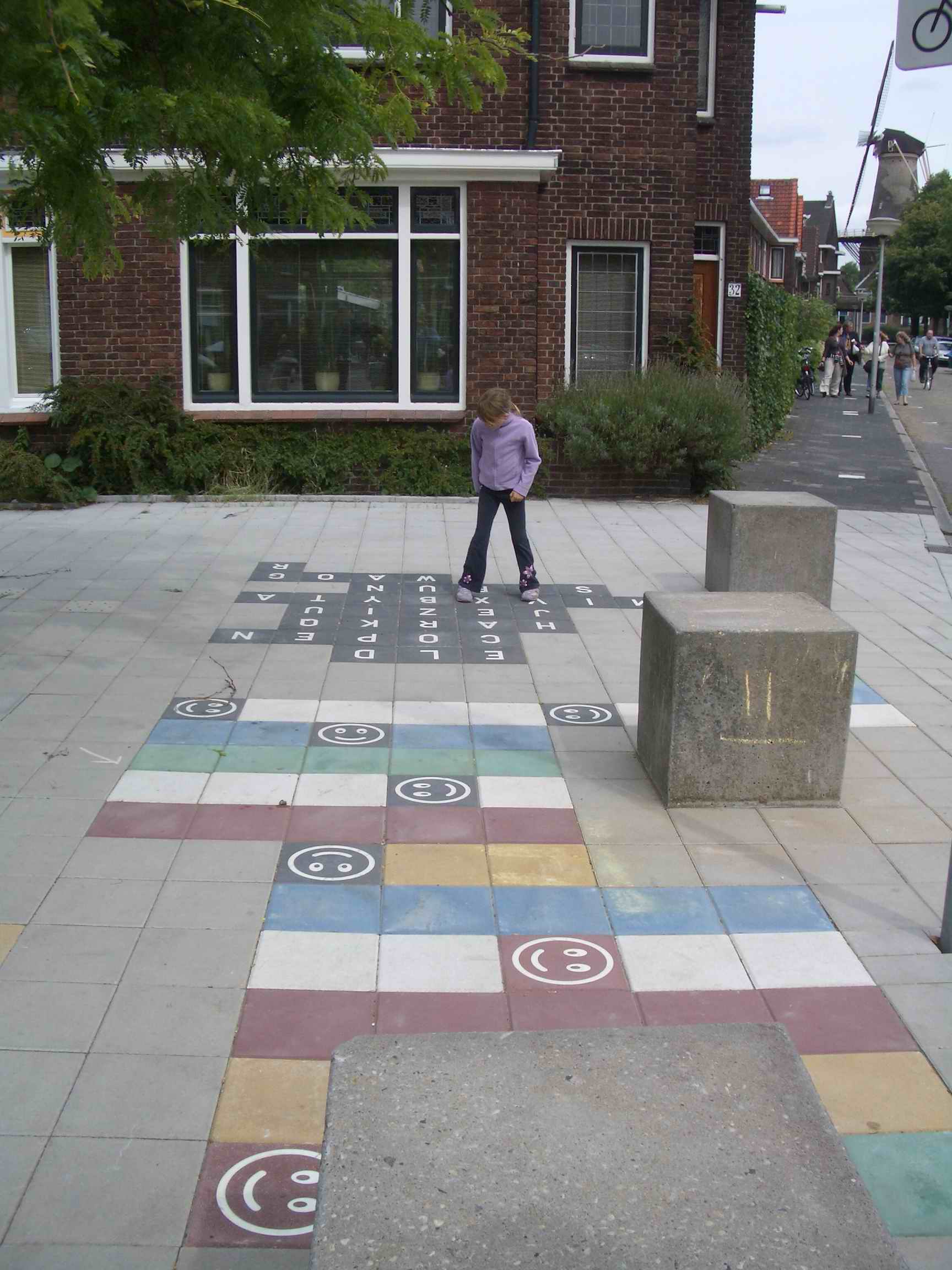 Child playing on pavement in residential area of Delft