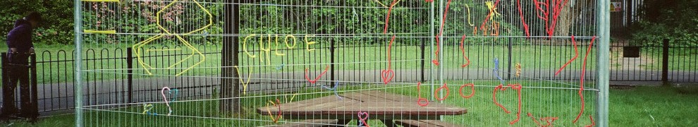 Fenced off park picnic table with yarn in the fencing